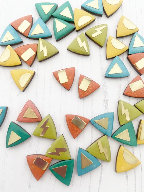hand painted geometric triangle studs in orange with brass bars added.