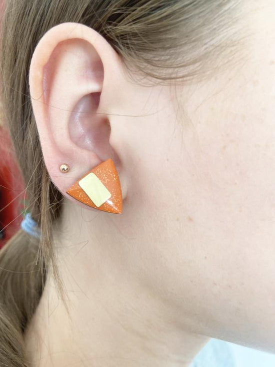 hand painted geometric triangle studs in orange with brass bars added.