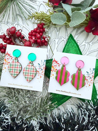 Two pairs of Christmas bauble dangle earrings displayed on white cards with The Messy Brunette branding
