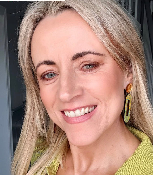 Michelle Up the Lane wearing blue and yellow long drop earrings by the messy brunette