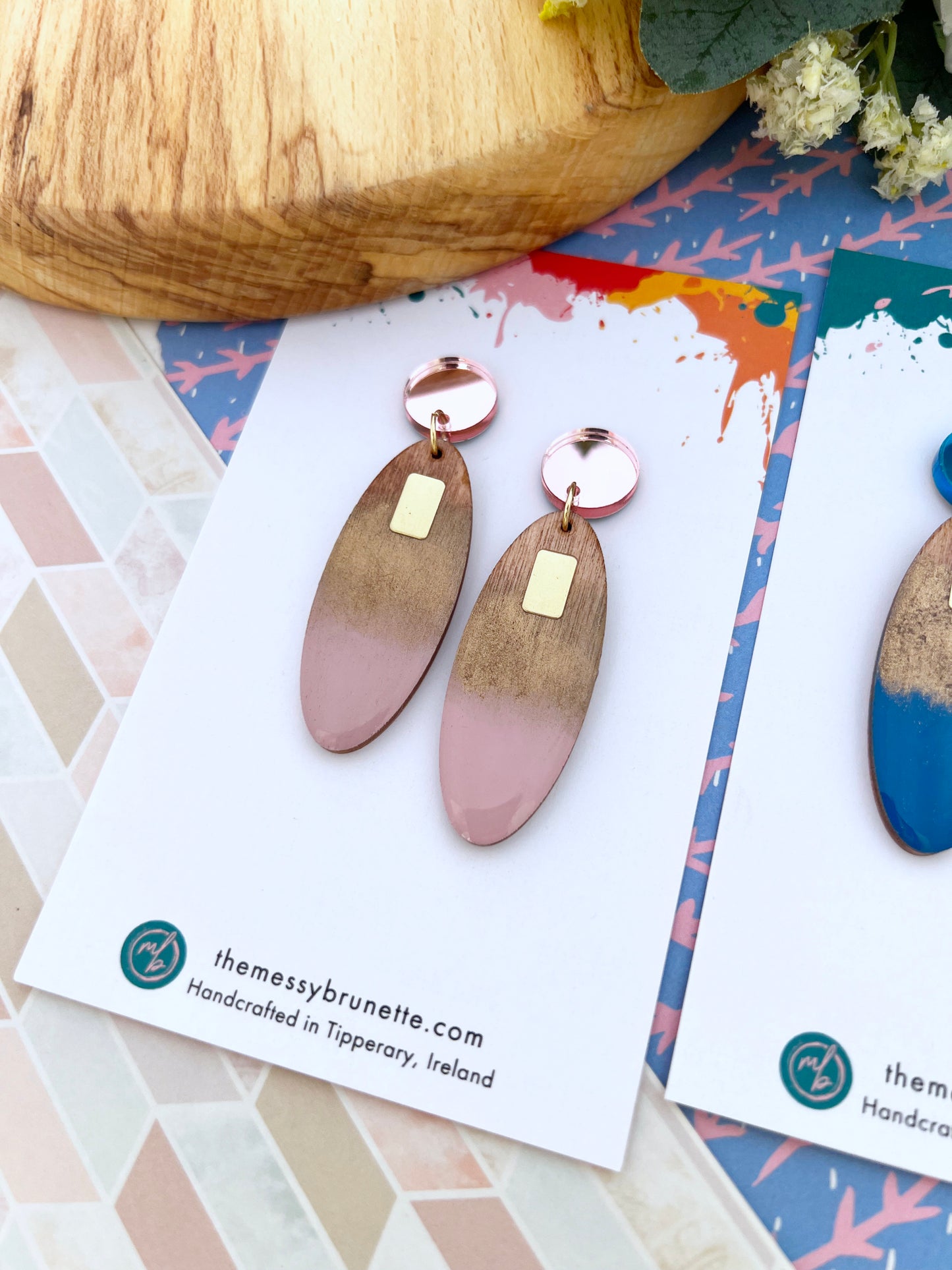 Wooden earrings with pink gradient on a branded card with 'themessybrunette.com' branding.