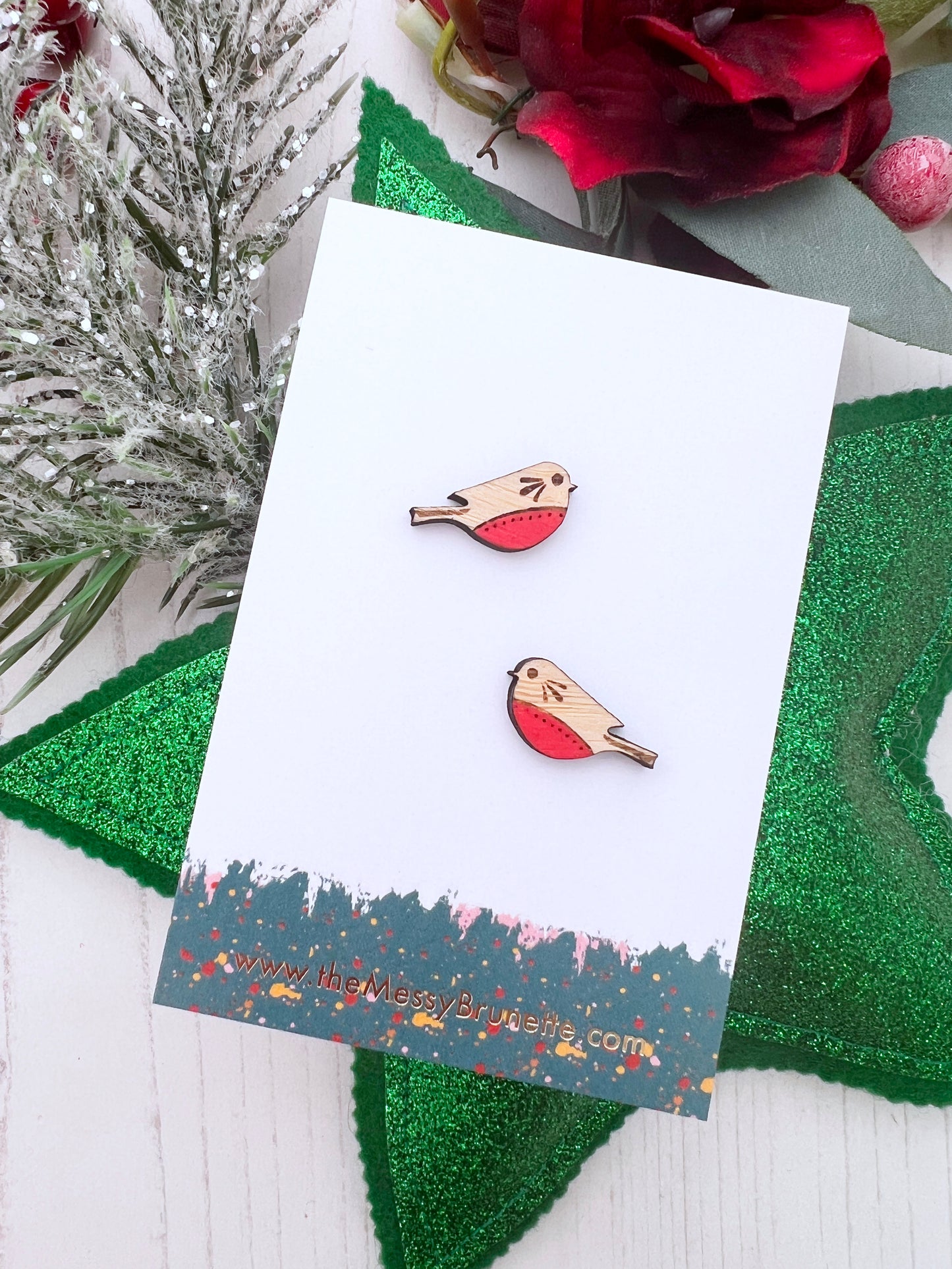 Robin wood stud earrings on a branded The Messy Brunette Jewellery Card with decorations behind 