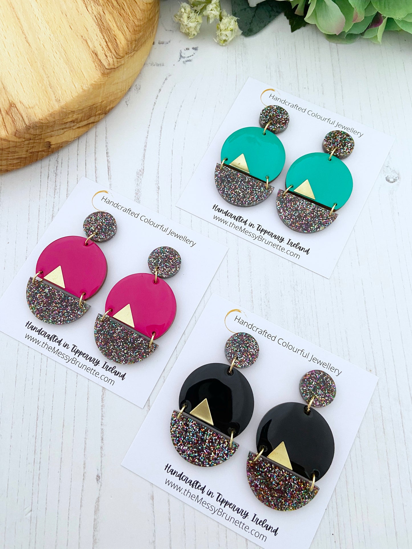 Colourful earrings on display with cards indicating 'Handcrafted Colourful Jewellery' from Tipperary, Ireland.