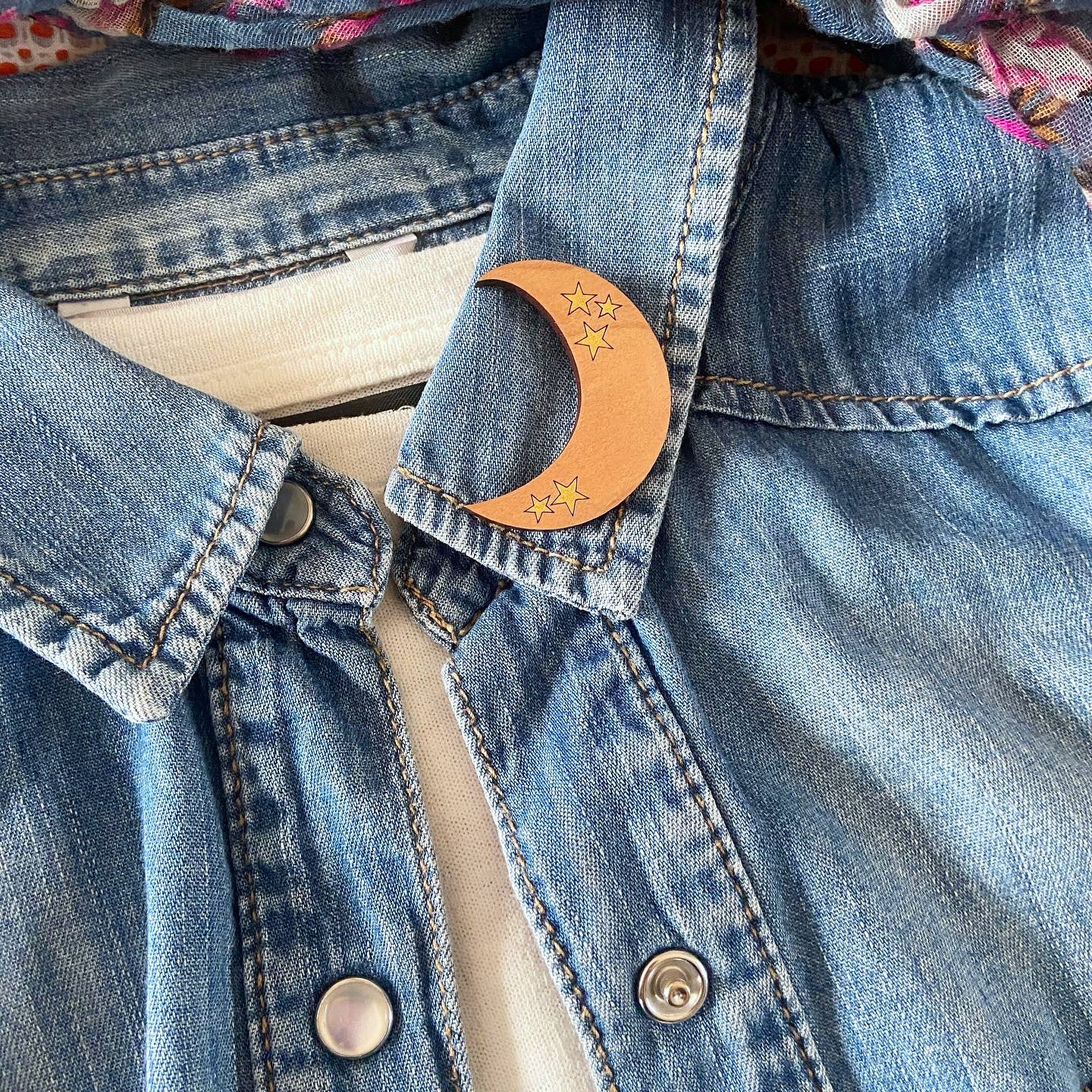 Denim jacket with a wood moon pin brooch 