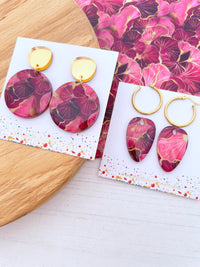 Pair of pink and gold floral earrings with gold accents on a floral-patterned card with 'The Messy Brunette' jewellery branding card