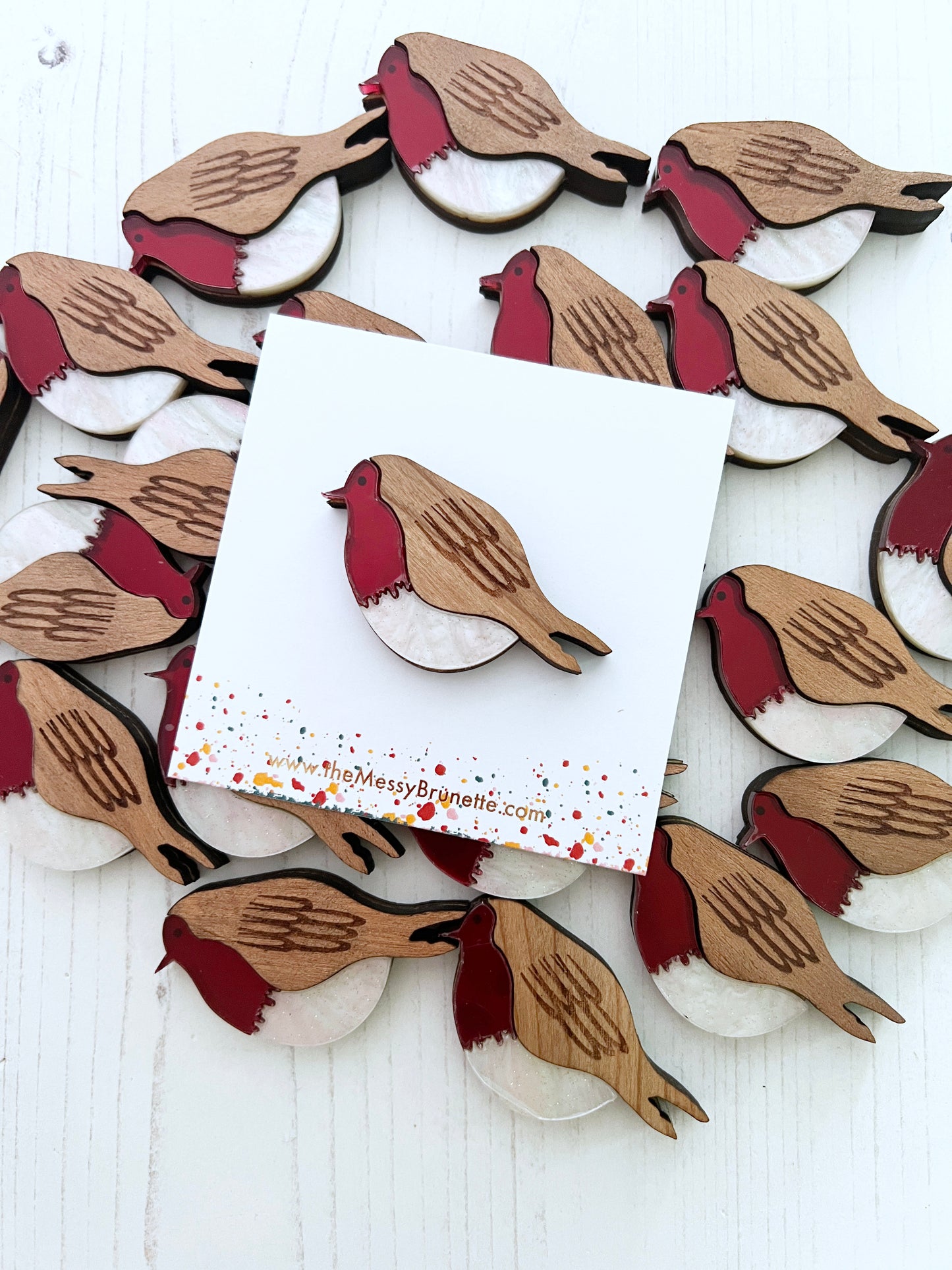 Wooden robin red breast brooch pin on a white card with 'The Messy Bronte' branding.