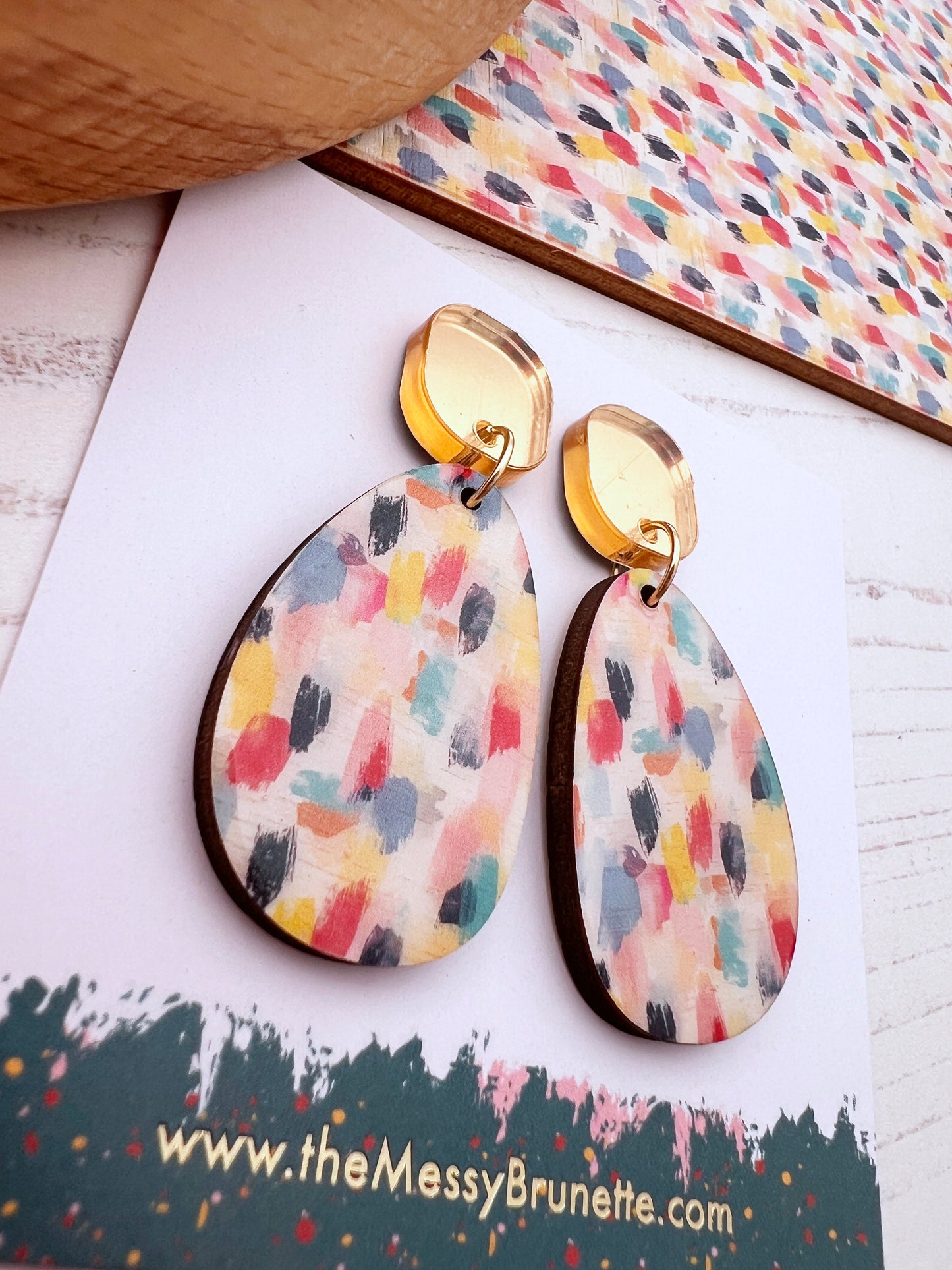 paint effect wooden earring on a card with the messy brunette branding