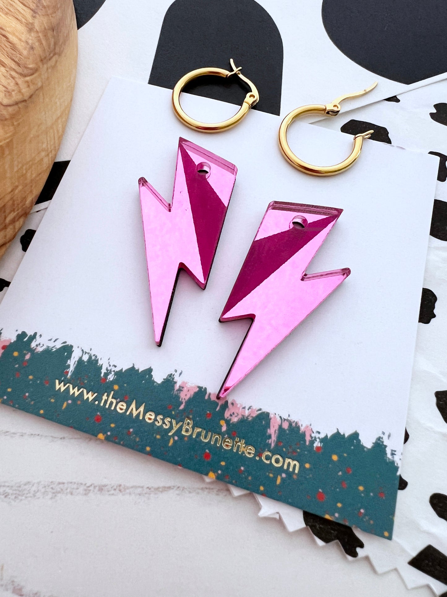 Pink lightning bolt earrings on a branded card with 'the Messy Brunette' website.