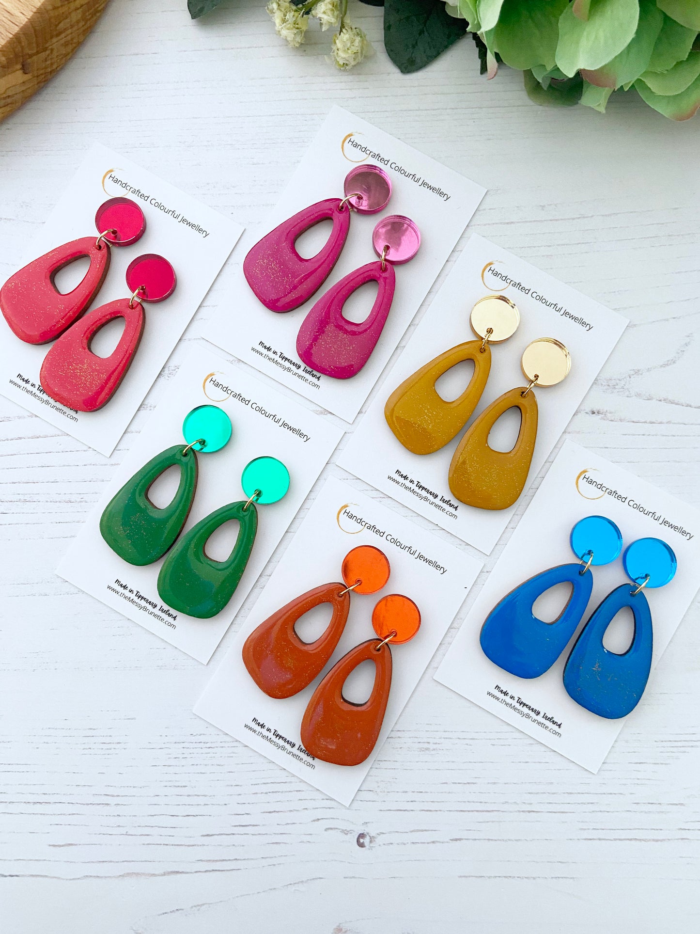 Jewel colour hand painted earring drops on cards with the Messy Brunette branding