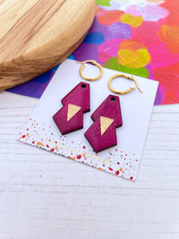 Pair of hot pink glitter earrings with gold accents on a colourful card.