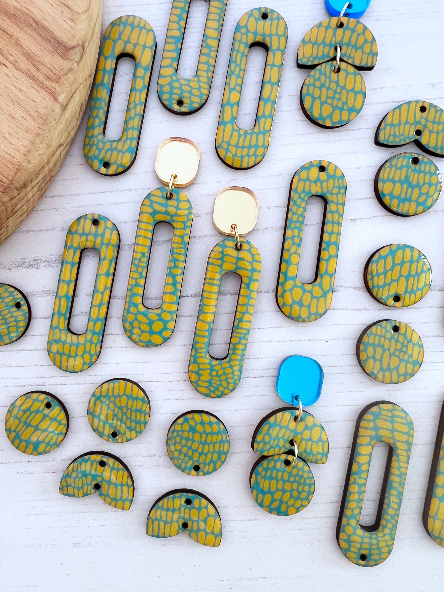 Colourful patterned earrings on a white surface