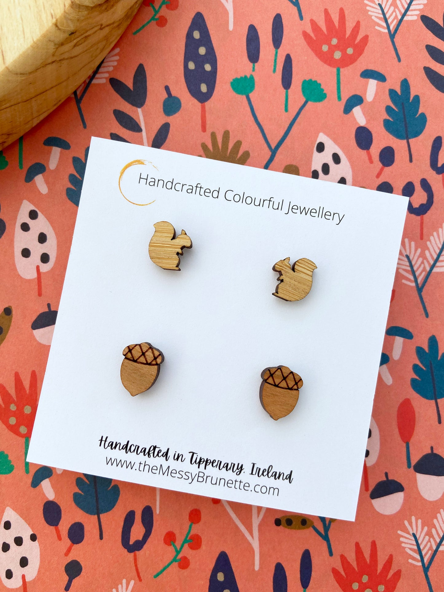 Small wooden acorn & squirrel shaped stud earrings on a 'The Messy Brunette' jewellery branded card