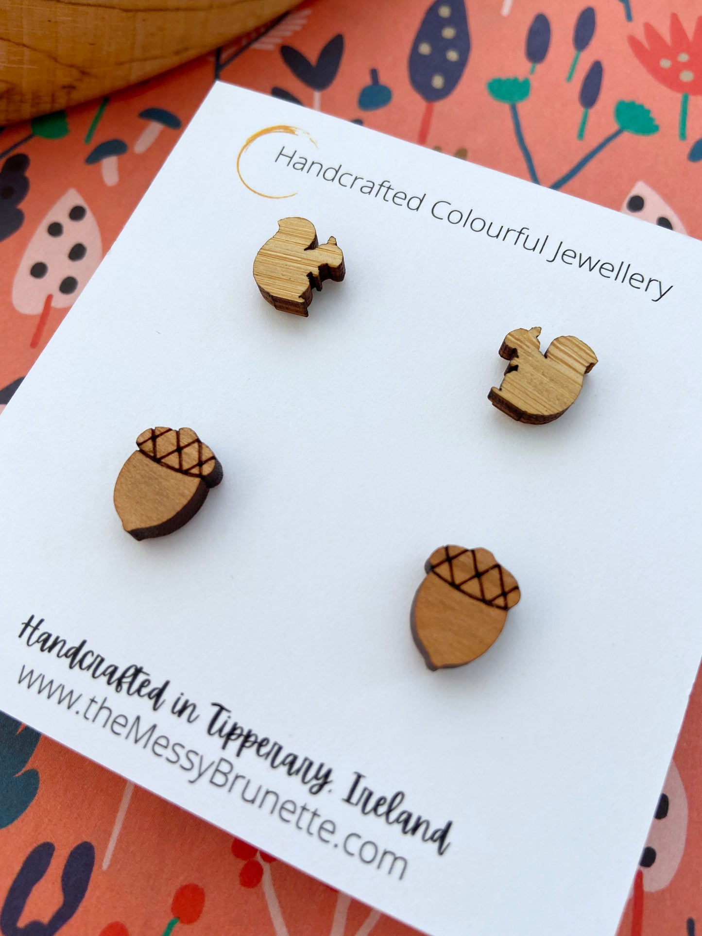 Small wooden acorn & squirrel shaped stud earrings on a 'The Messy Brunette' jewellery branded card