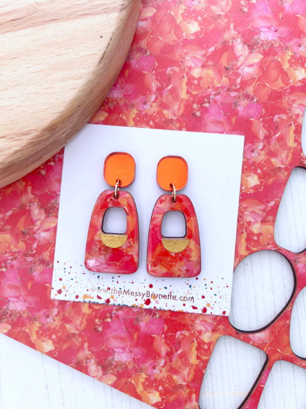Colorful orange and pink ink abstract earrings on a white background. Irish Made jewellery by The Messy Brunette