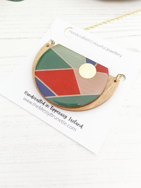 Geometric Wooden Necklace with shades of green, blue, red & pink.