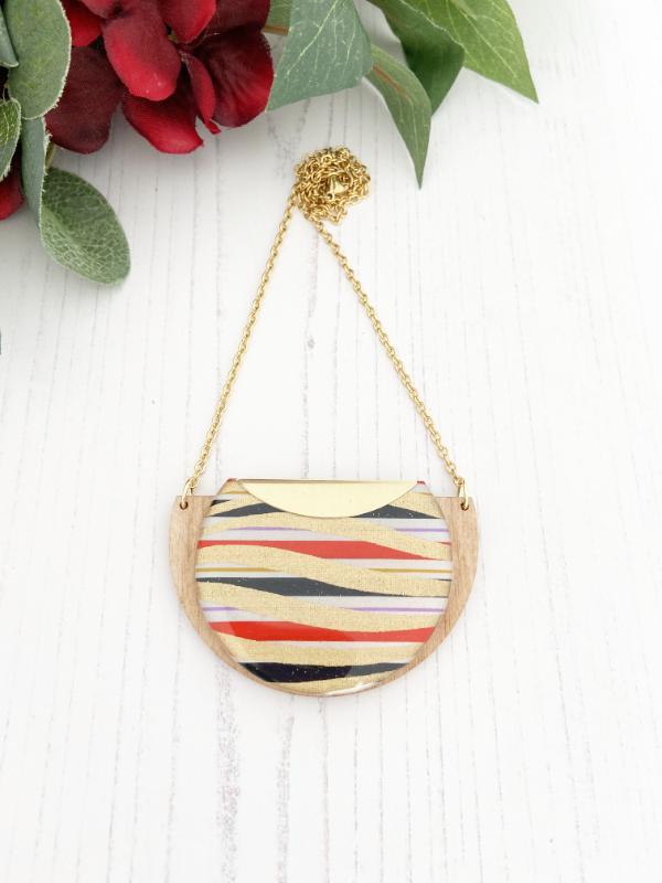 Gold Swirls Handmade Necklace made from FSC wood with gold swirls against black, white red stripes