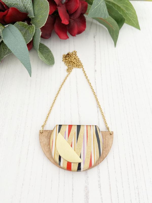 Gold Swirls Handmade Necklace made from FSC wood with gold swirls against black, white red stripes