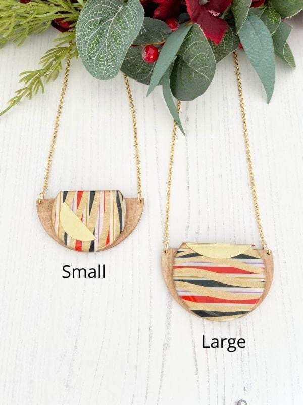 Gold Swirls Handmade Necklace made from FSC wood with gold swirls against black, white red stripes