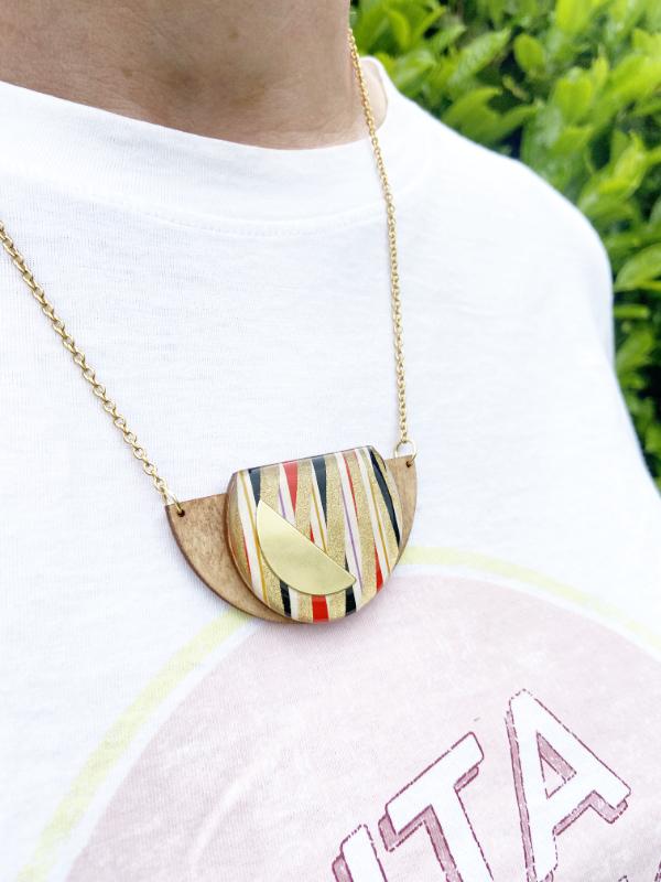 Gold Swirls Handmade Necklace made from FSC wood with gold swirls against black, white red stripes