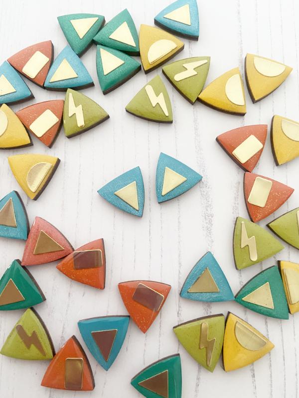 Load image into Gallery viewer, hand painted triangle earrings in metallic blue and green with brass triangles added.

