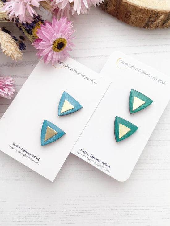 hand painted triangle earrings in metallic blue and green with brass triangles added.