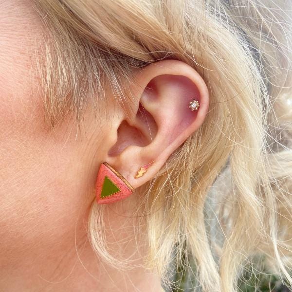 Hand painted orange triangle studs made from birch plywood.