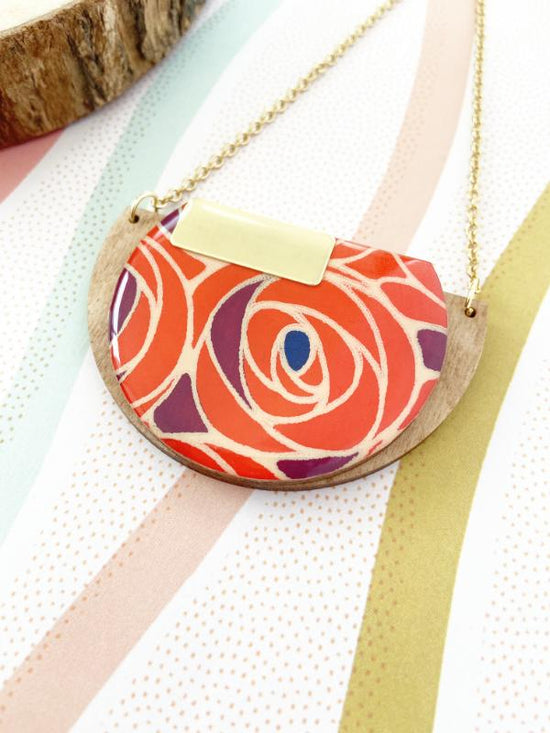 handmade wood necklace made with hand screened paper with a rose design, finished with resin and stainless steel chain