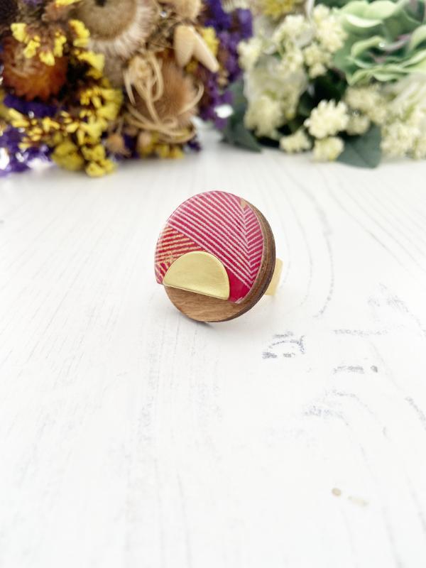Load image into Gallery viewer, Trendy Fashion Ring, handmade from birch ply wood and hand screened paper in shades of red, while and gold. Come with gold hammered base
