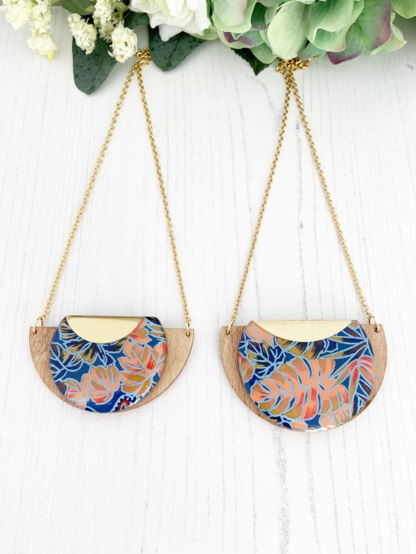 Tropical Leaf Handmade Wooden Necklace, made with FSC birch and hand screened paper with a leaf design in shades of blue, red and peach, finished with gold necklace